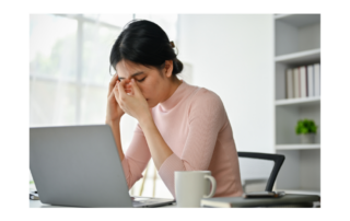 Woman looking at a computer feeling a lack of clear thinking